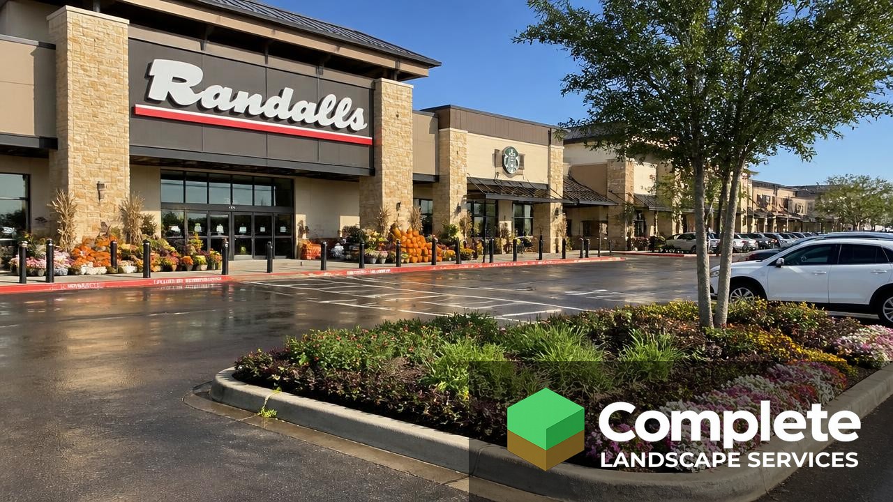 Retail centre entrance with seasonal flower displays and maintained parking lot landscape islands