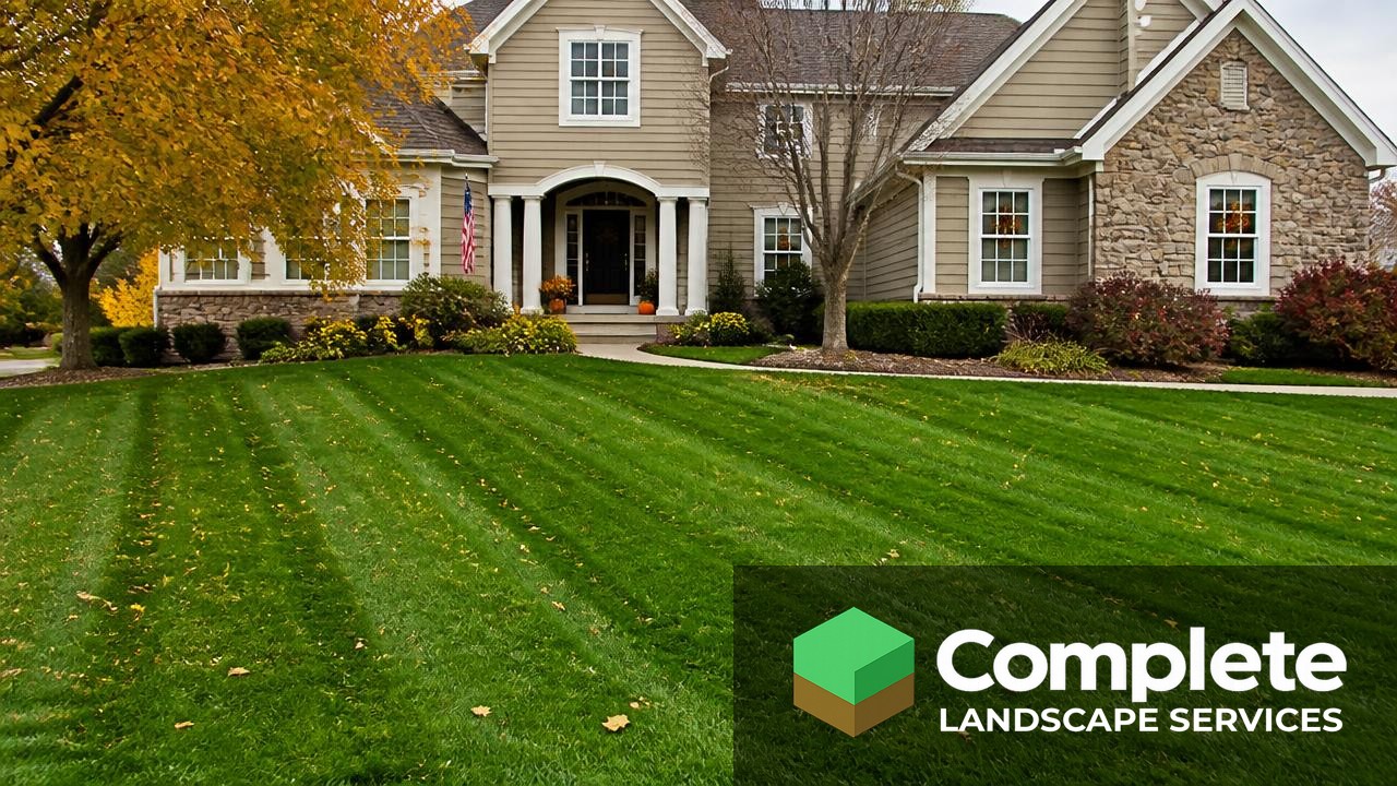 Deep green striped lawn in front of a suburban home in autumn